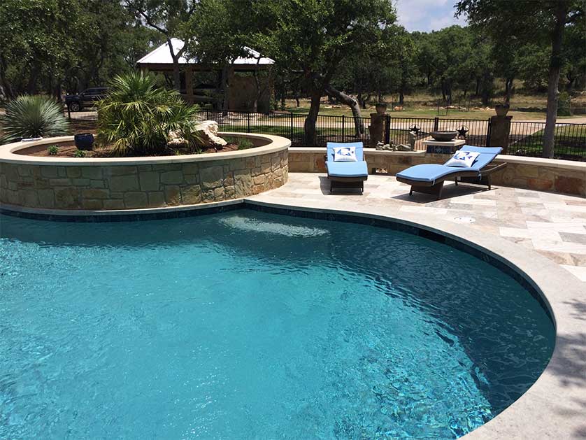 Gorgeous custom pool with lounge chairs next to it.